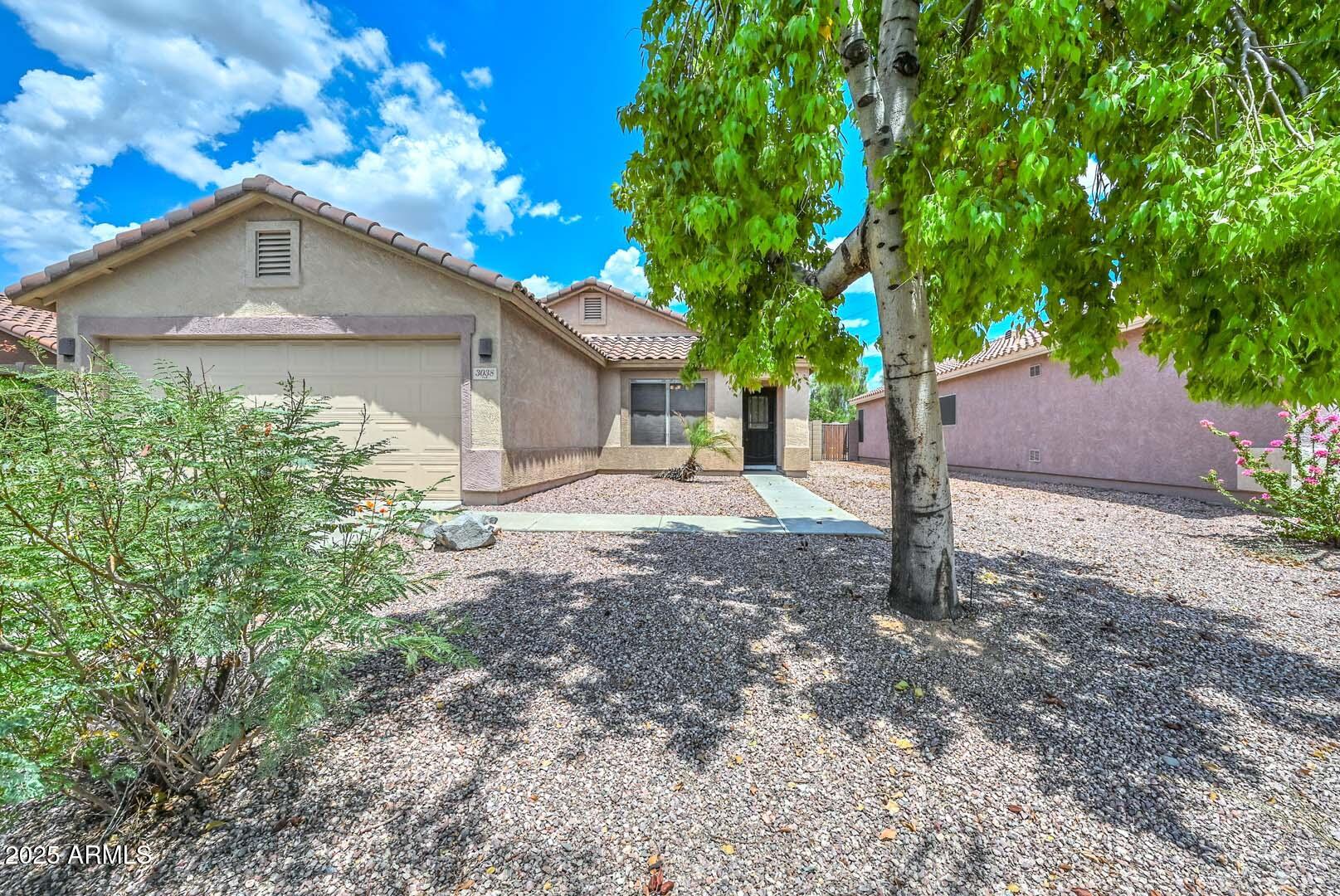 3038 West Roberta Drive Phoenix, AZ 85083 - Photo 2 of 40 a front view of a house with a yard and garage