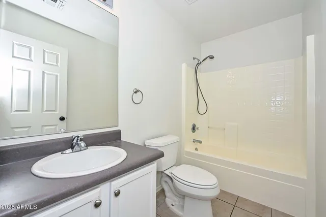 a bathroom with a granite countertop sink a toilet and shower