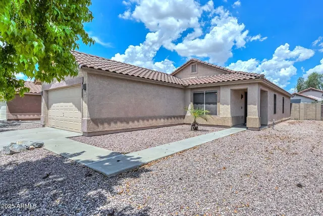 a front view of a house with a yard and a garage