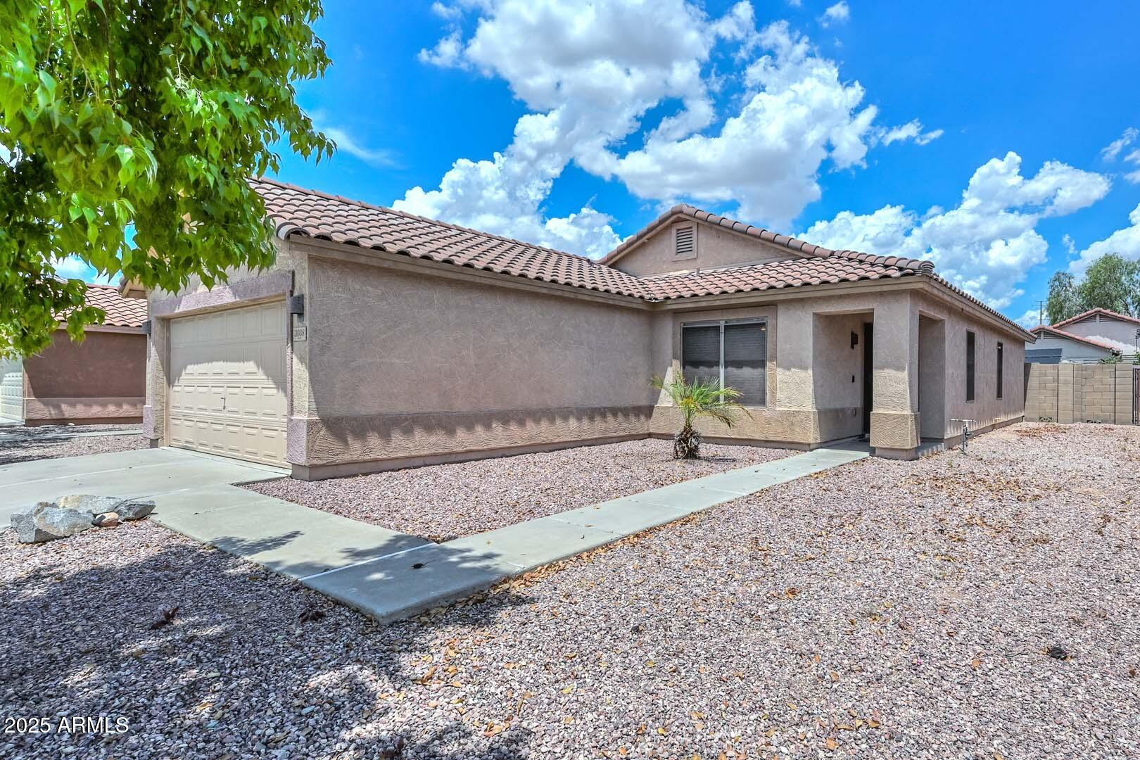 3038 West Roberta Drive Phoenix, AZ 85083 - Photo 3 of 40 a front view of a house with a yard and a garage