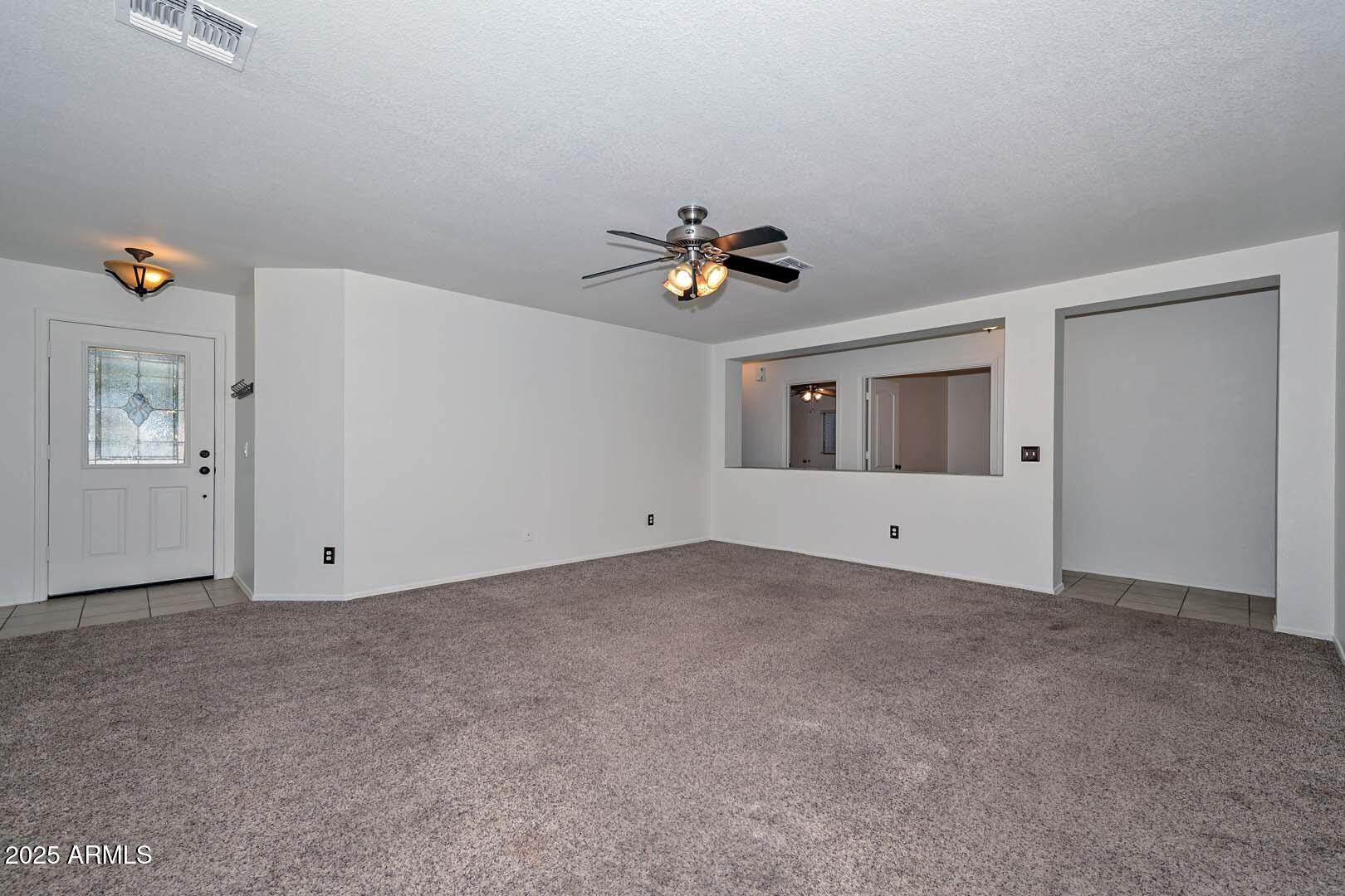 3038 West Roberta Drive Phoenix, AZ 85083 - Photo 7 of 40 an empty room with closet and windows