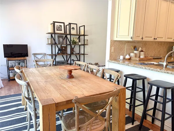 a dining table with chairs and cabinets