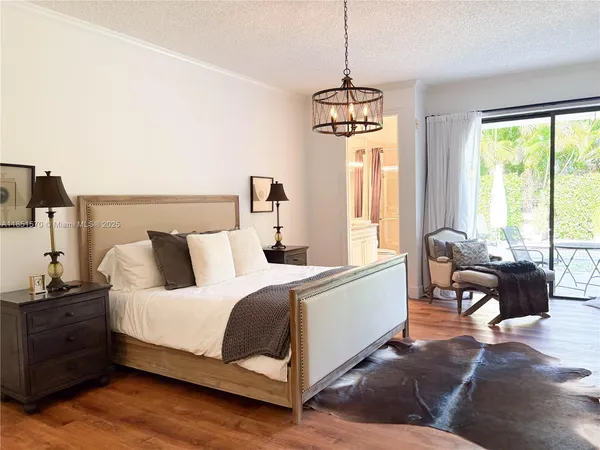 a spacious bedroom with a bed and a window