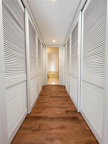 a view of hallway with wooden floor