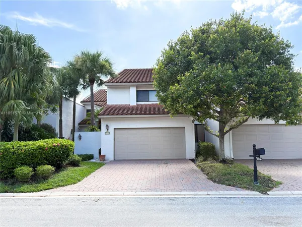 a front view of house with yard and green space