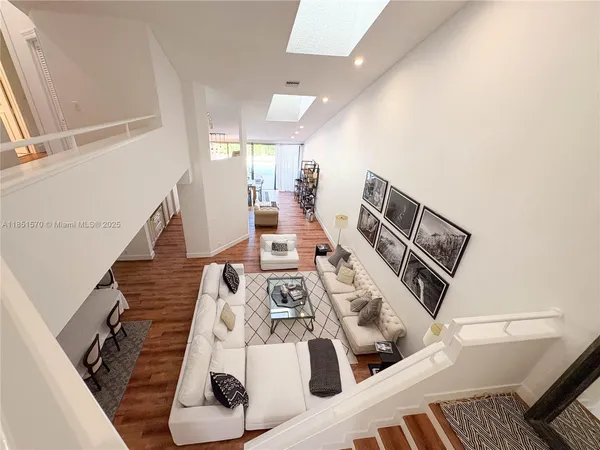 a view of living room with furniture and wooden floor