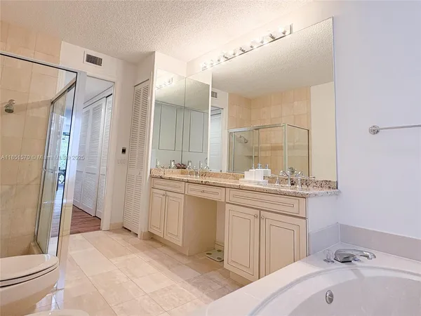 a bathroom with a sink and mirror with toilet