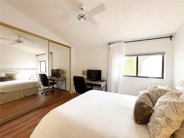 a bed room with a bed and a chair