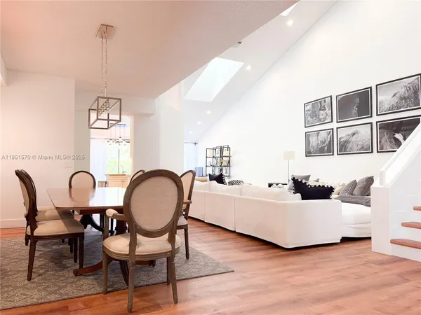 a living room with furniture a table and a window