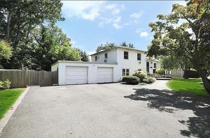 26 Venus Road Syosset, NY 11791 - Photo 2 of 8 a front view of a house with a yard and garage