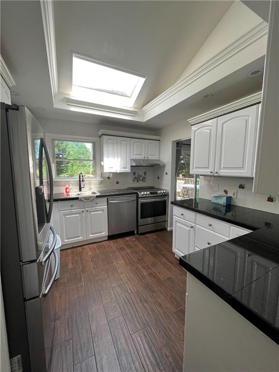 26 Venus Road Syosset, NY 11791 - Photo 7 of 8 a large kitchen with stainless steel appliances granite countertop wooden cabinets a refrigerator a sink a stove a microwave and wooden floors