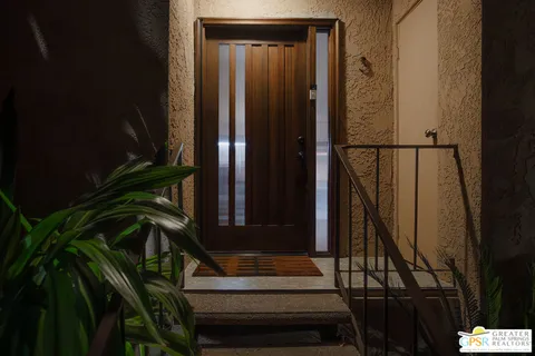 a view of entryway with wooden floor and stairs