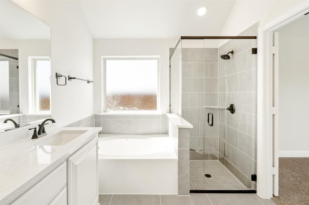 11916 Serval Street Godley, TX 76044 - Photo 20 of 35 a bathroom with a shower sink and mirror