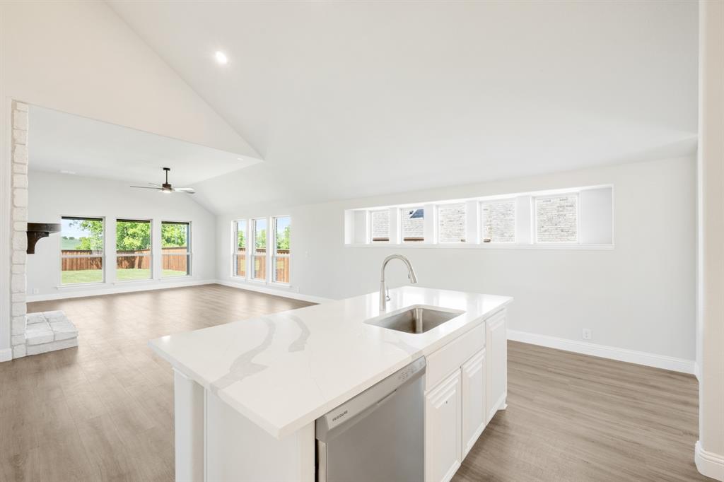 11916 Serval Street Godley, TX 76044 - Photo 10 of 35 a kitchen with a sink and a large window