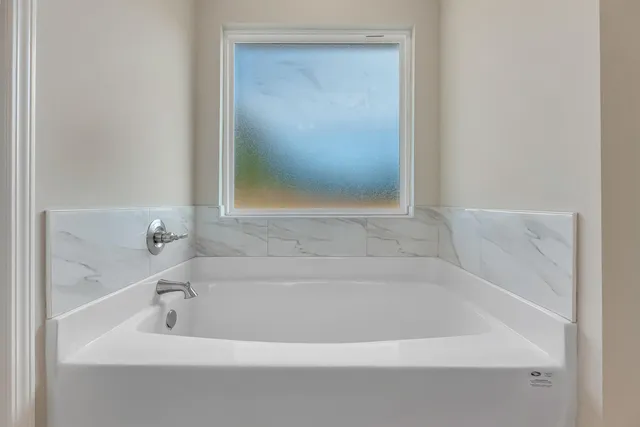 a white bath tub sitting in a bathroom