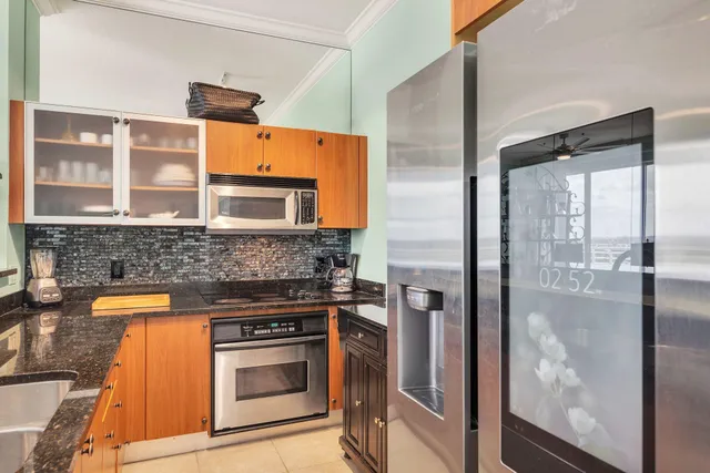a kitchen with stainless steel appliances granite countertop a stove and a refrigerator