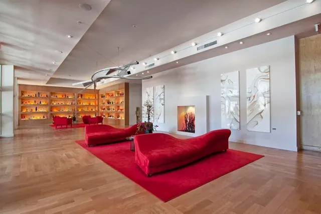 a bedroom with furniture and a large window