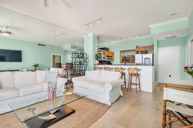 a living room with furniture and kitchen view