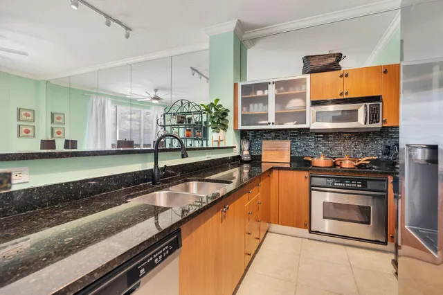 a kitchen with stainless steel appliances granite countertop a stove and a sink