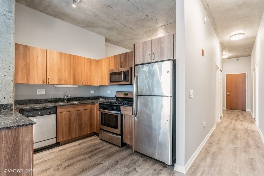 235 West Van Buren Street, Unit 1822 Chicago, IL 60607 - Photo 14 of 29 a kitchen with stainless steel appliances granite countertop a refrigerator stove and sink