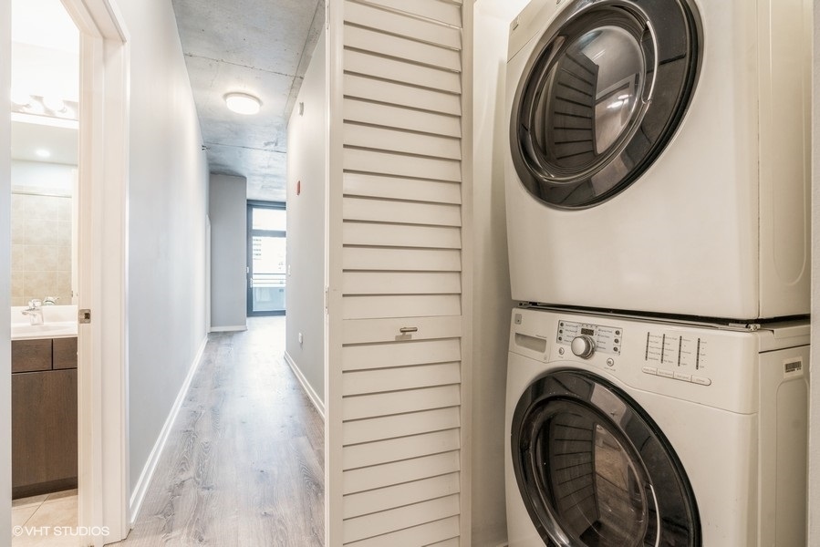 235 West Van Buren Street, Unit 1822 Chicago, IL 60607 - Photo 21 of 29 a view of a hallway with washer and dryer