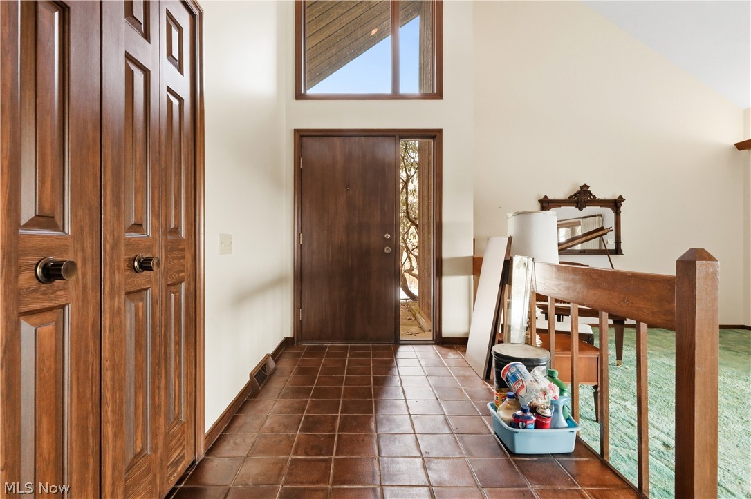 7014 River Styx Road Medina, OH 44256 - Photo 2 of 50 Foyer entrance featuring high vaulted ceiling and dark tile patterned floors