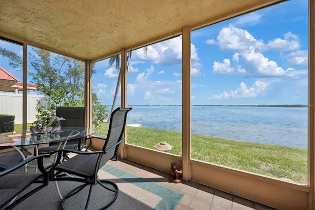 a living room with furniture and large windows