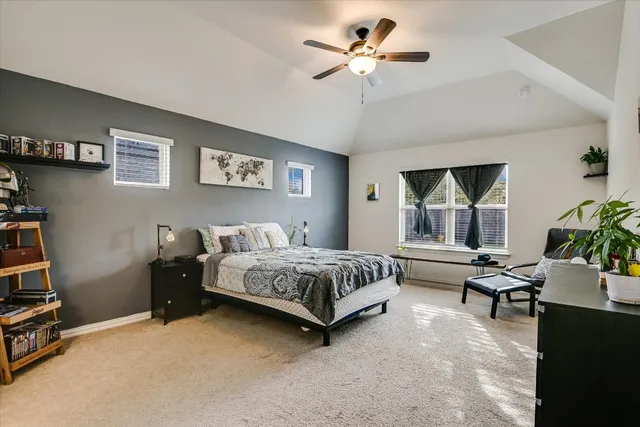 a living room with furniture kitchen and a wooden floor