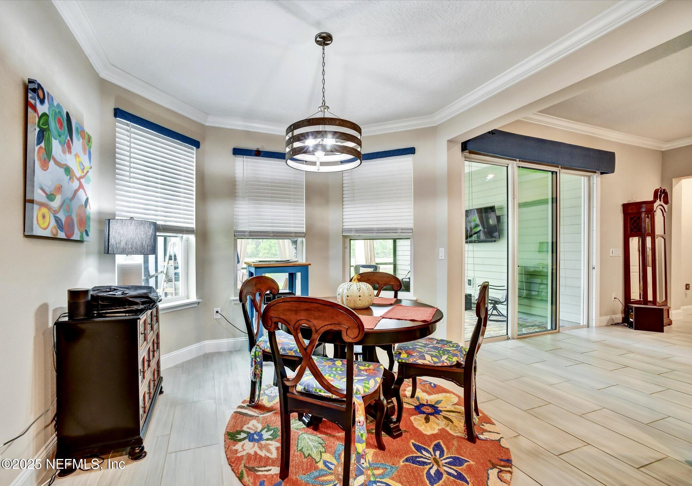 166 Oleta Way St. Augustine, FL 32095 - Photo 12 of 29 a dining room with furniture a chandelier and window
