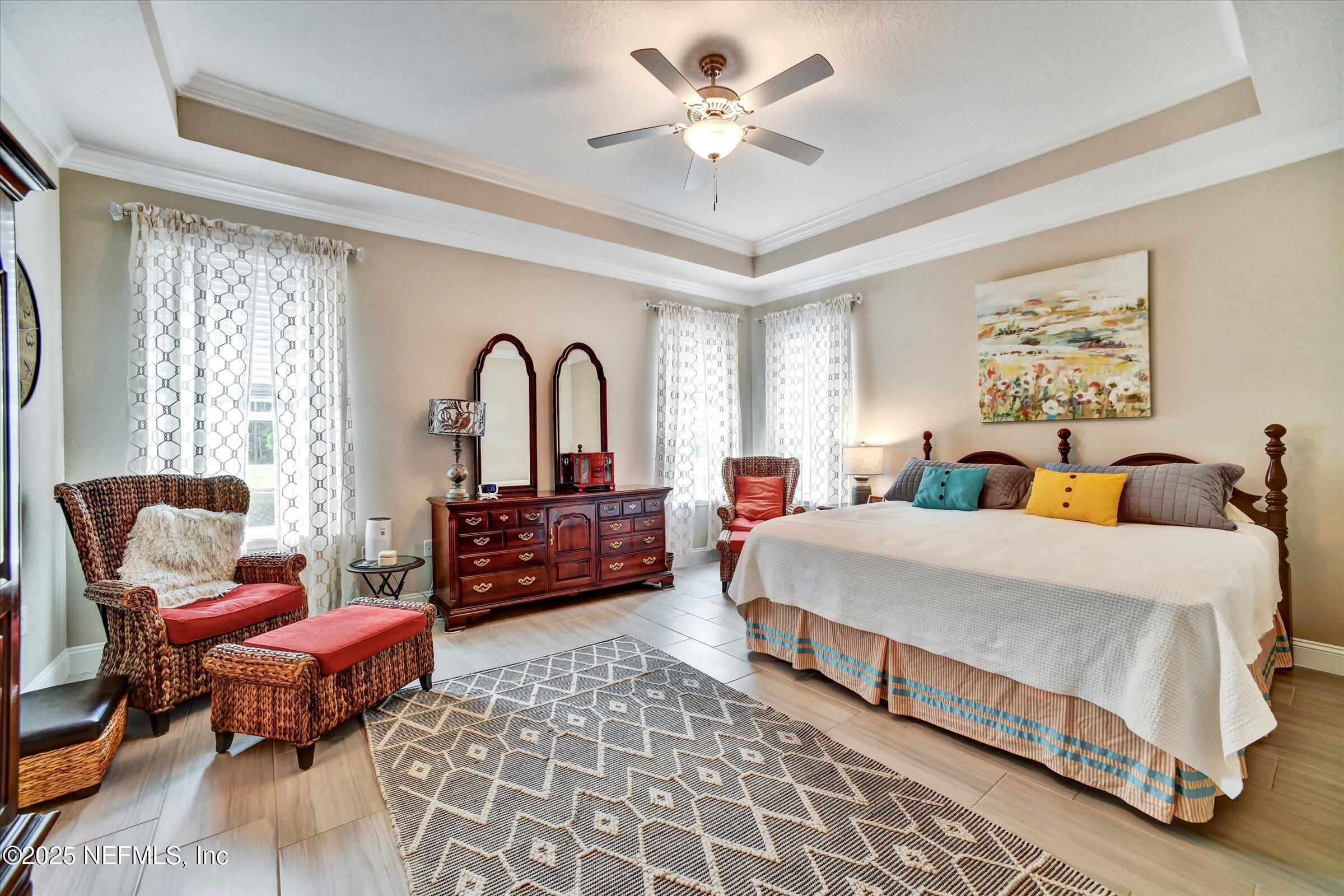 166 Oleta Way St. Augustine, FL 32095 - Photo 13 of 29 a spacious bedroom with a bed and a chandelier