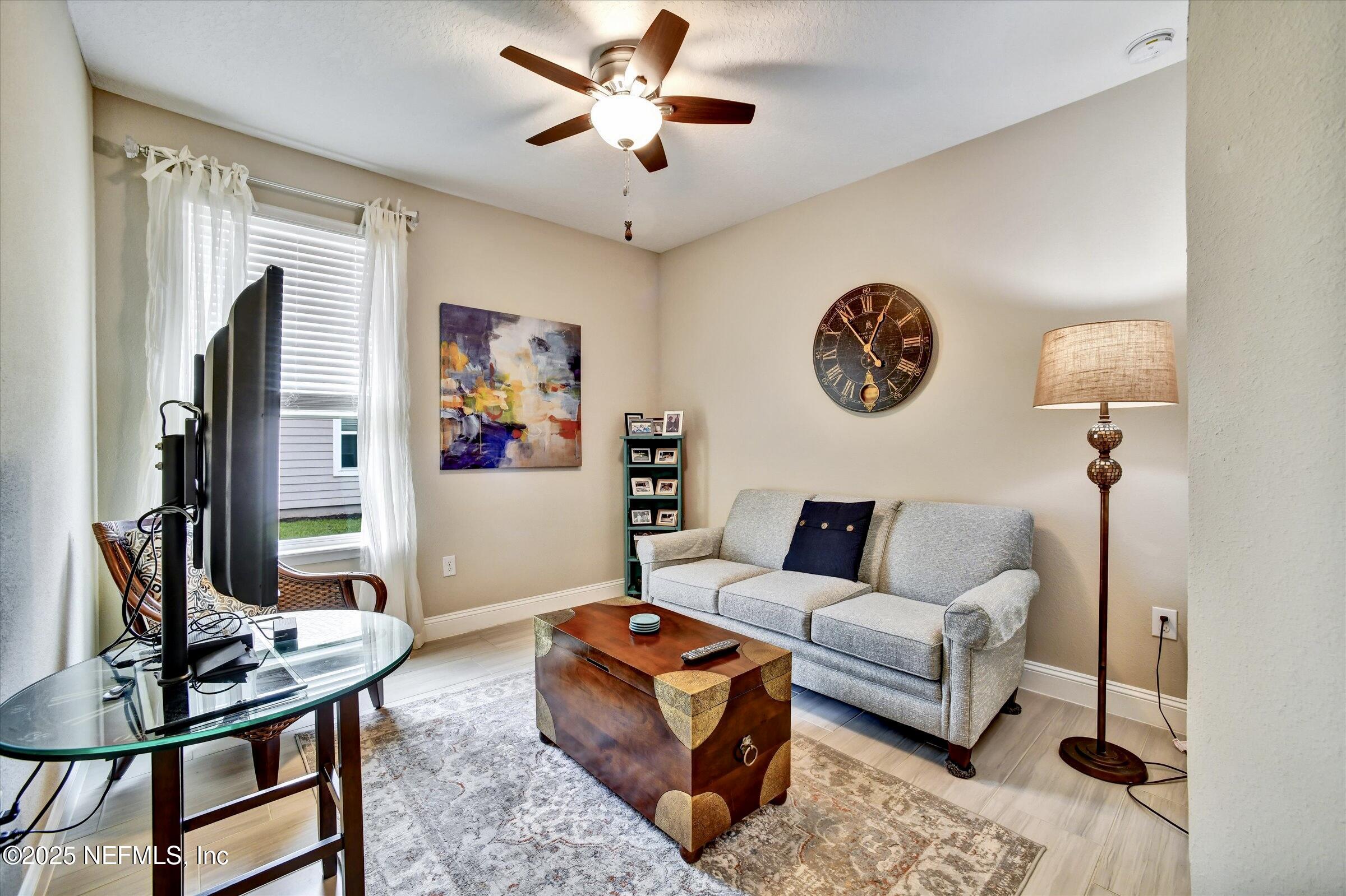 166 Oleta Way St. Augustine, FL 32095 - Photo 20 of 29 a living room with furniture and a flat screen tv