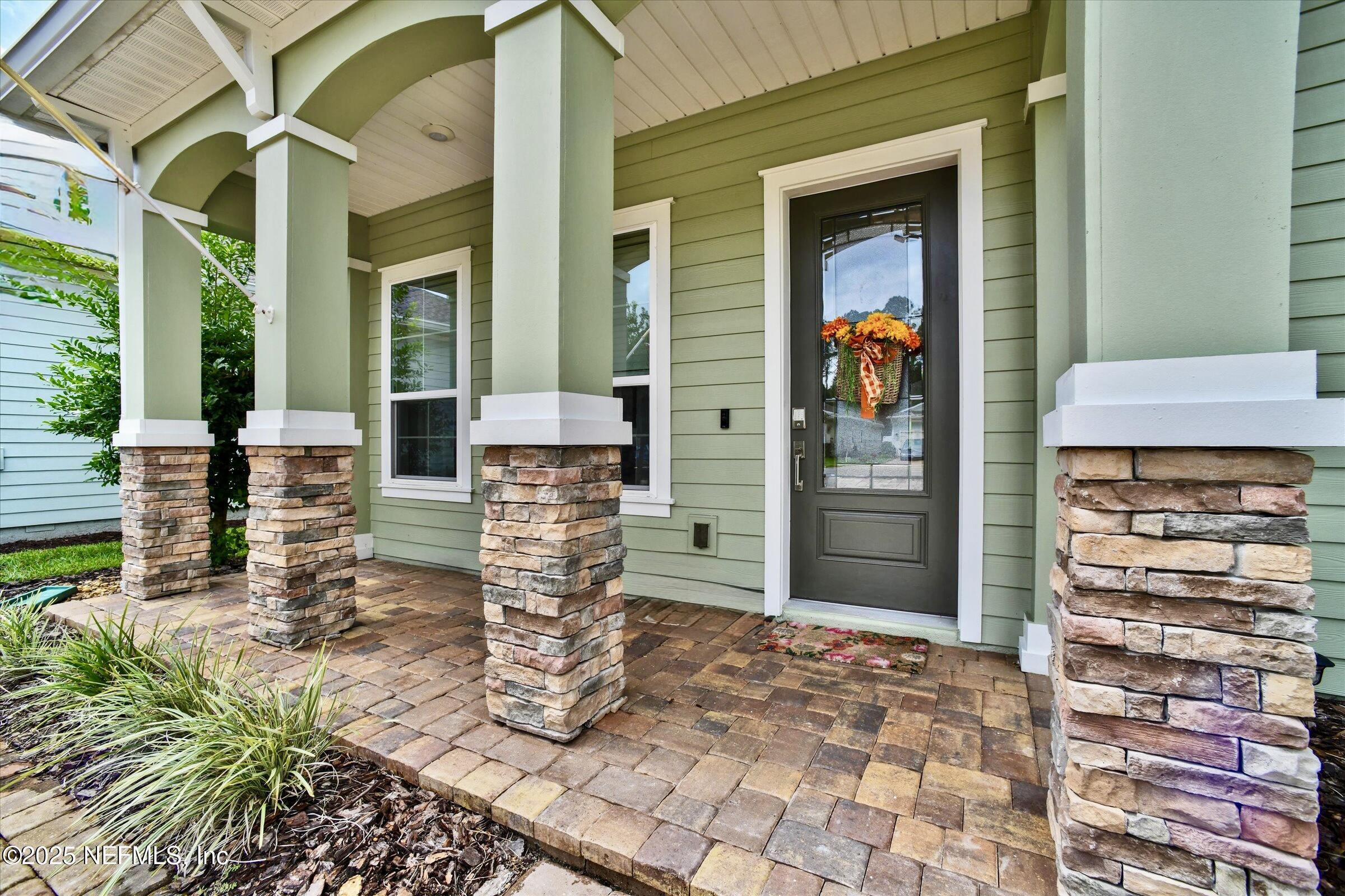 166 Oleta Way St. Augustine, FL 32095 - Photo 2 of 29 a view of a porch with potted plants