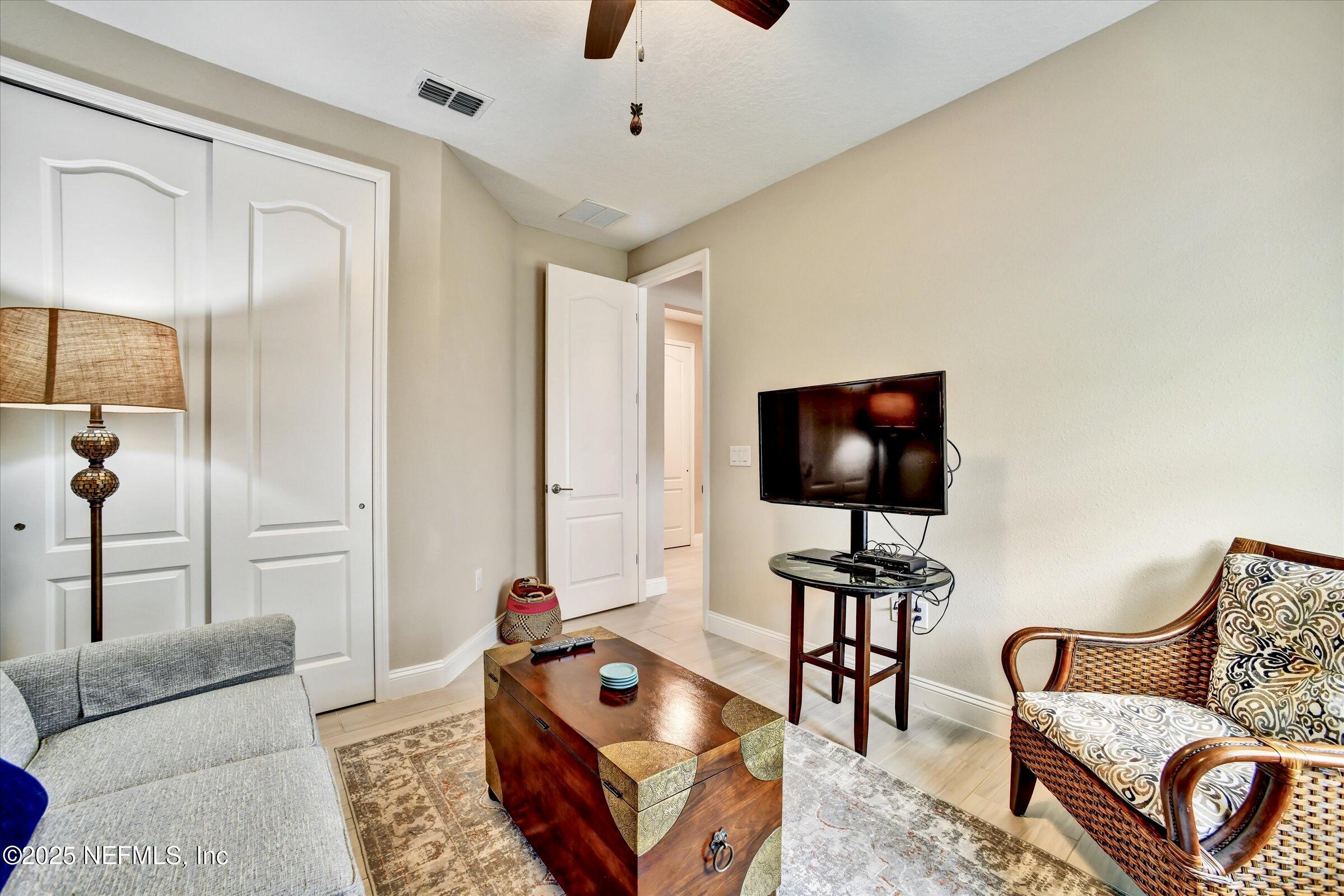 166 Oleta Way St. Augustine, FL 32095 - Photo 21 of 29 a living room with furniture and a flat screen tv