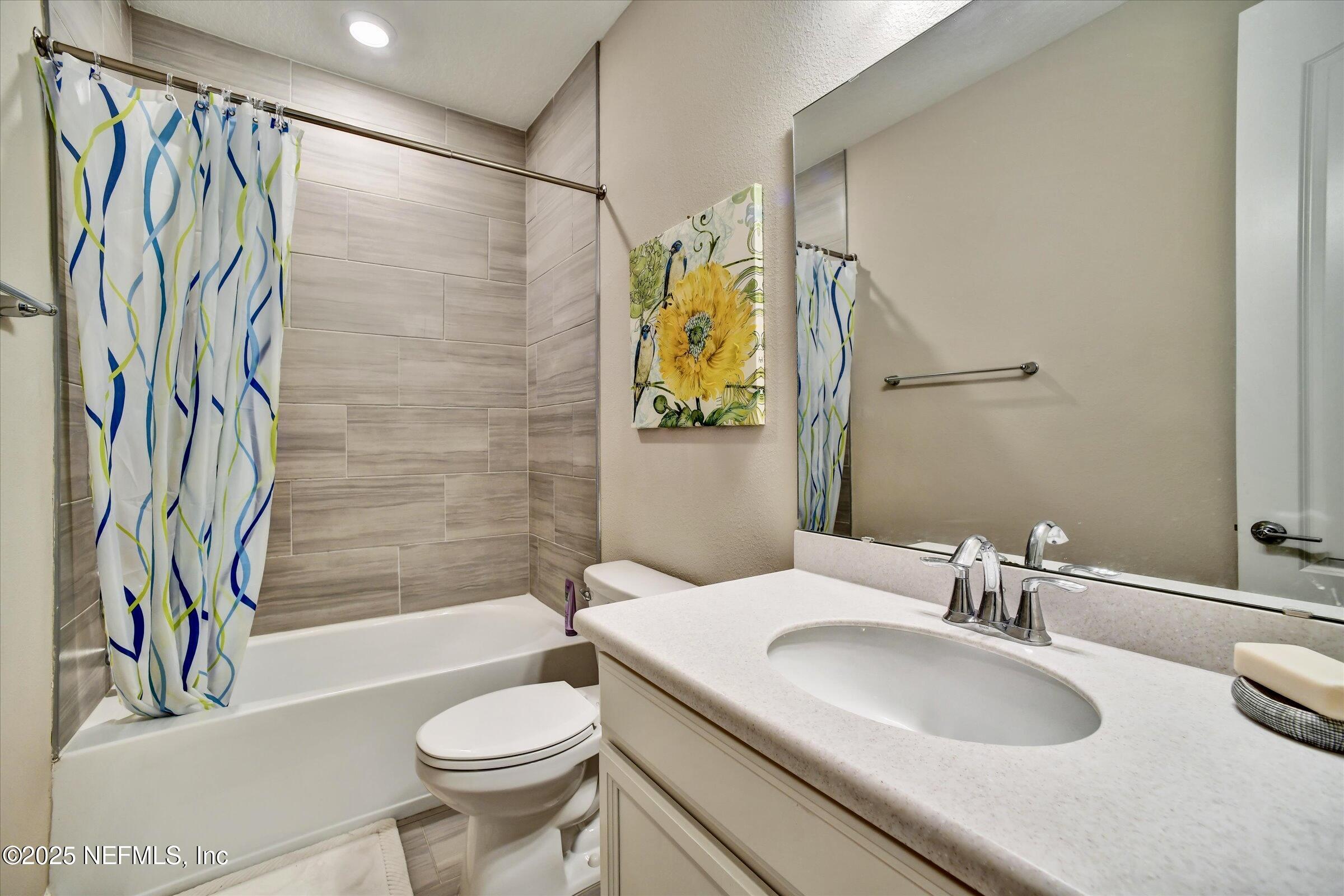 166 Oleta Way St. Augustine, FL 32095 - Photo 22 of 29 a bathroom with a sink a toilet and shower