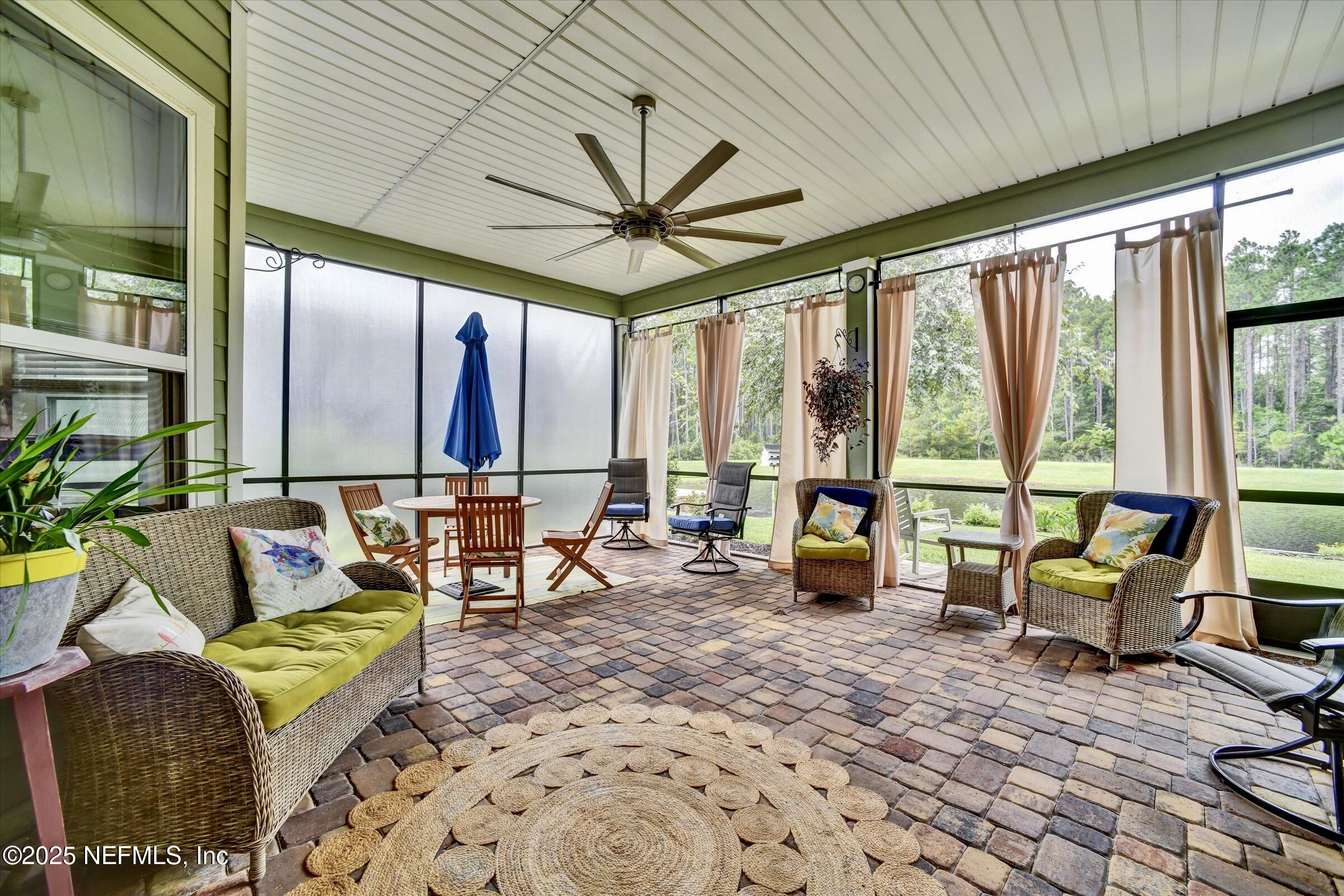 166 Oleta Way St. Augustine, FL 32095 - Photo 24 of 29 a living room with furniture and floor to ceiling windows