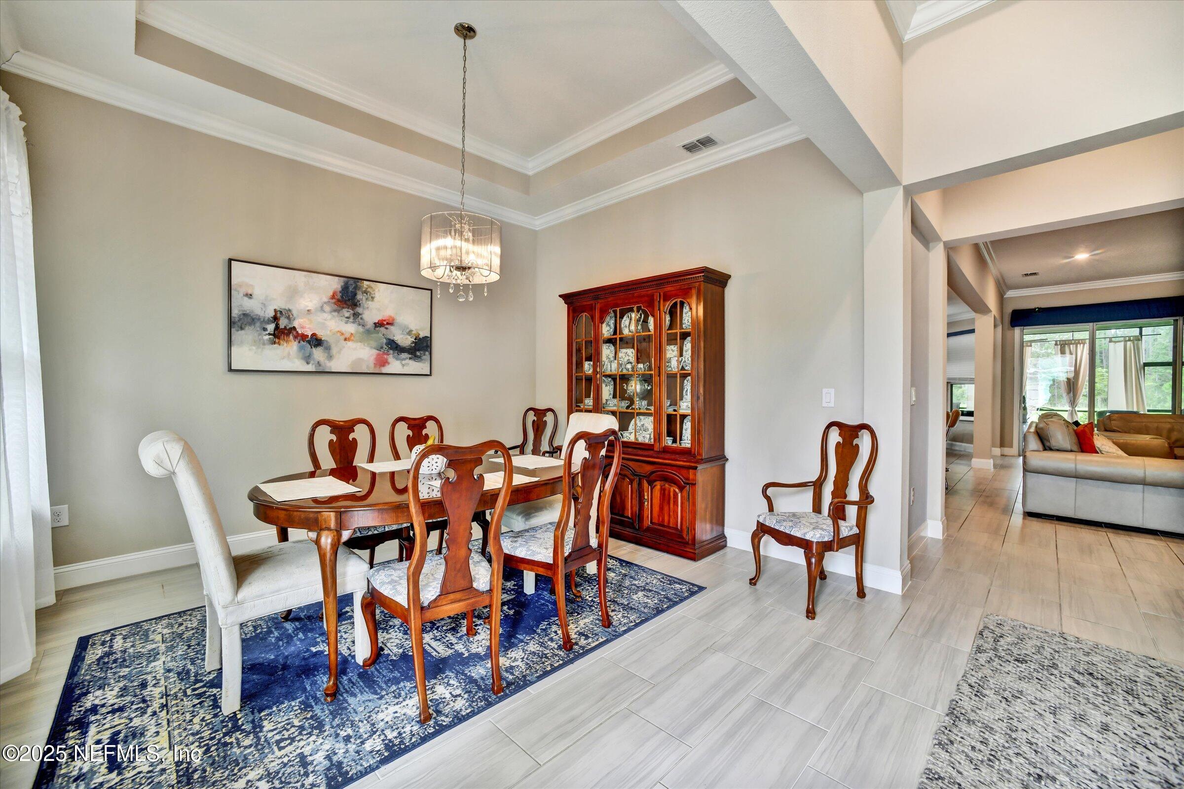 166 Oleta Way St. Augustine, FL 32095 - Photo 3 of 29 a dining room with furniture and wooden floor