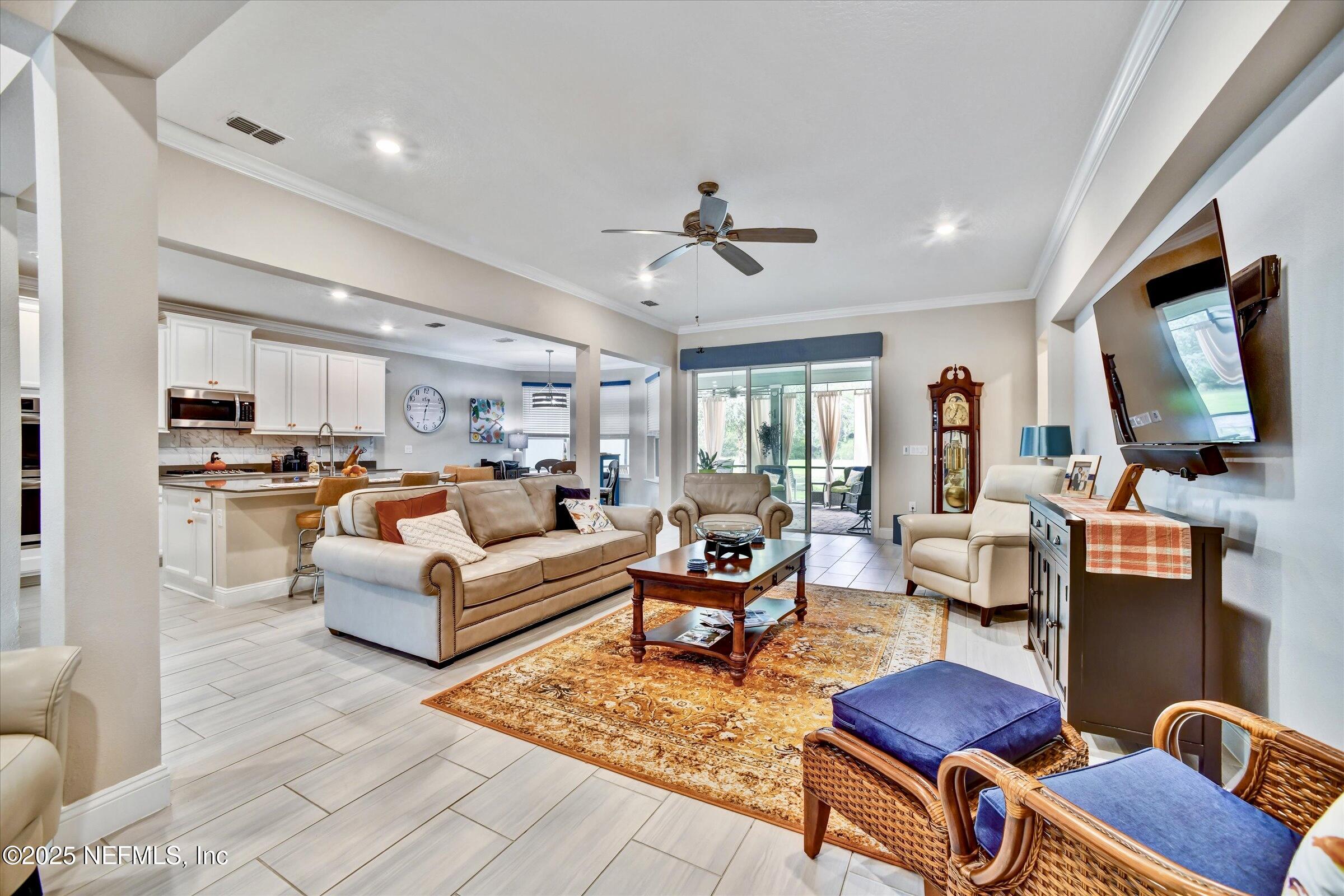 166 Oleta Way St. Augustine, FL 32095 - Photo 7 of 29 a living room with furniture flat screen tv and couches