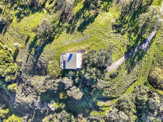 a living room with fireplace furniture and a large window