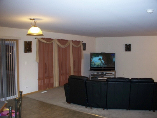 315 Ridgestone Trail Poplar Grove, IL 61065 - Photo 4 of 10 a living room with furniture and a flat screen tv