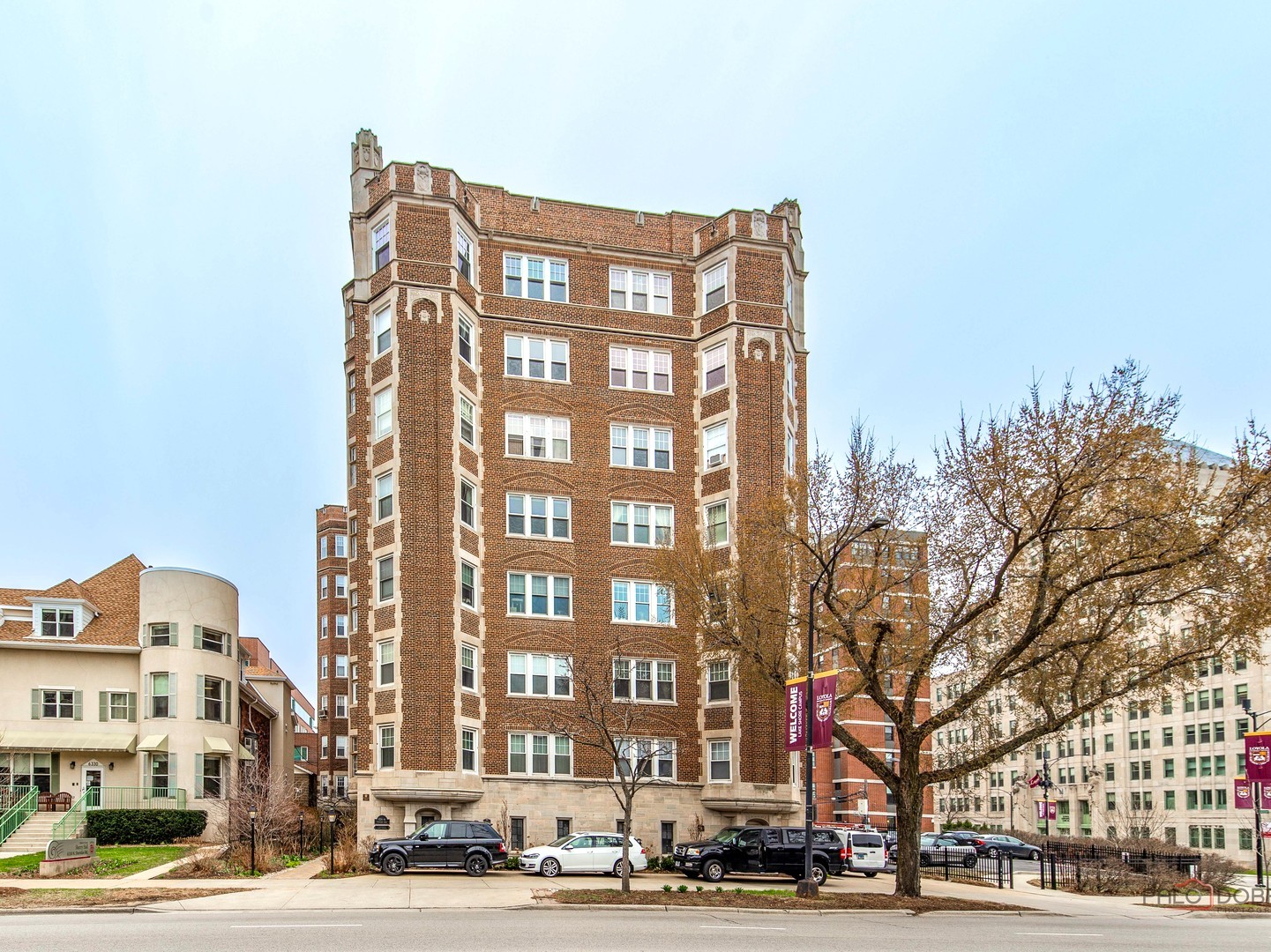 6342 North Sheridan Road, Unit 2B Chicago, IL 60660 - Photo 1 of 18 a front view of a building with lot of cars and trees