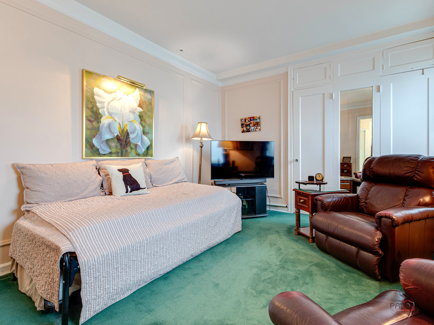 6342 North Sheridan Road, Unit 2B Chicago, IL 60660 - Photo 12 of 18 a room with a bed a couch and a flat screen tv