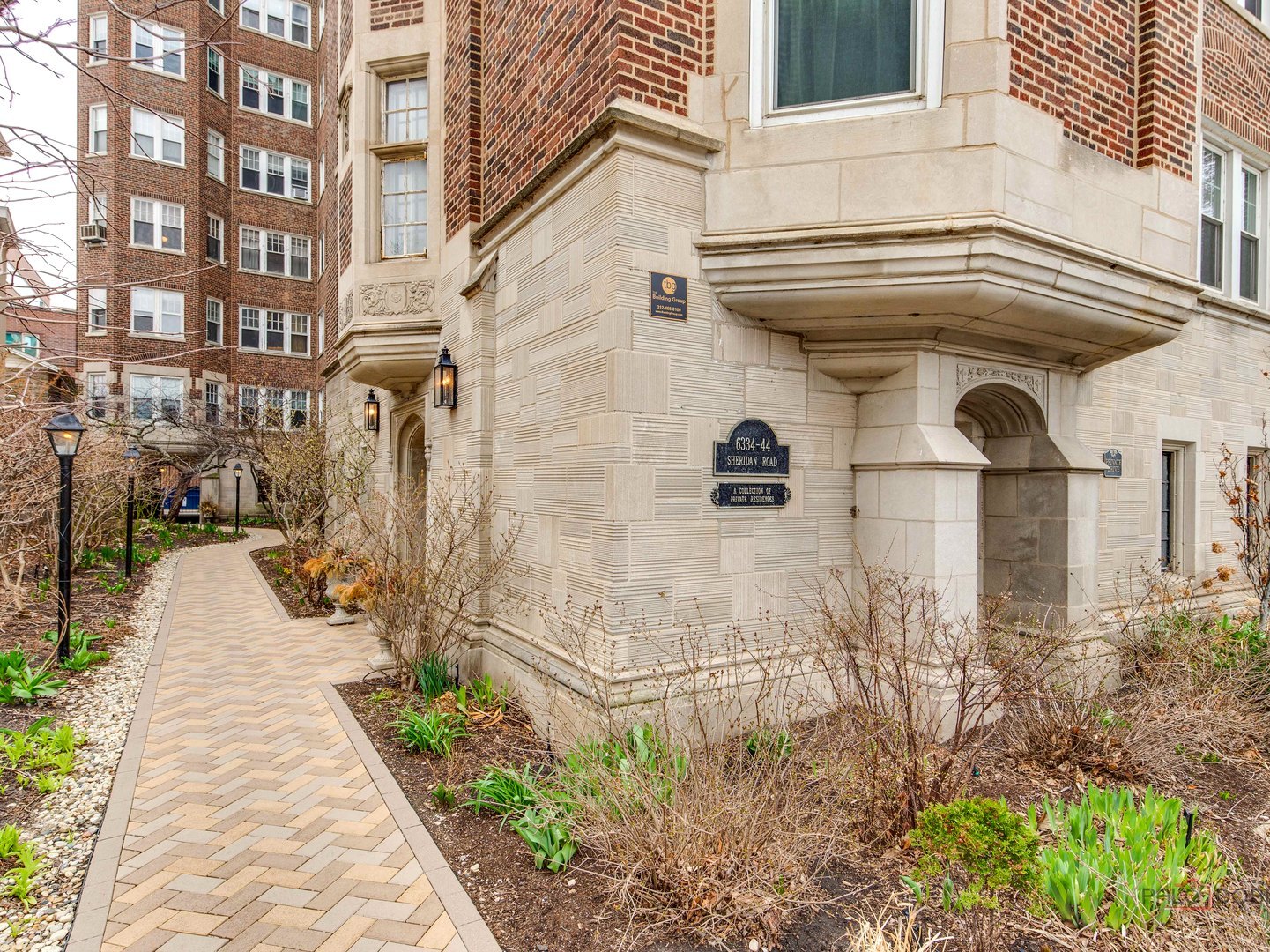 6342 North Sheridan Road, Unit 2B Chicago, IL 60660 - Photo 2 of 18 front view of a brick house with a street