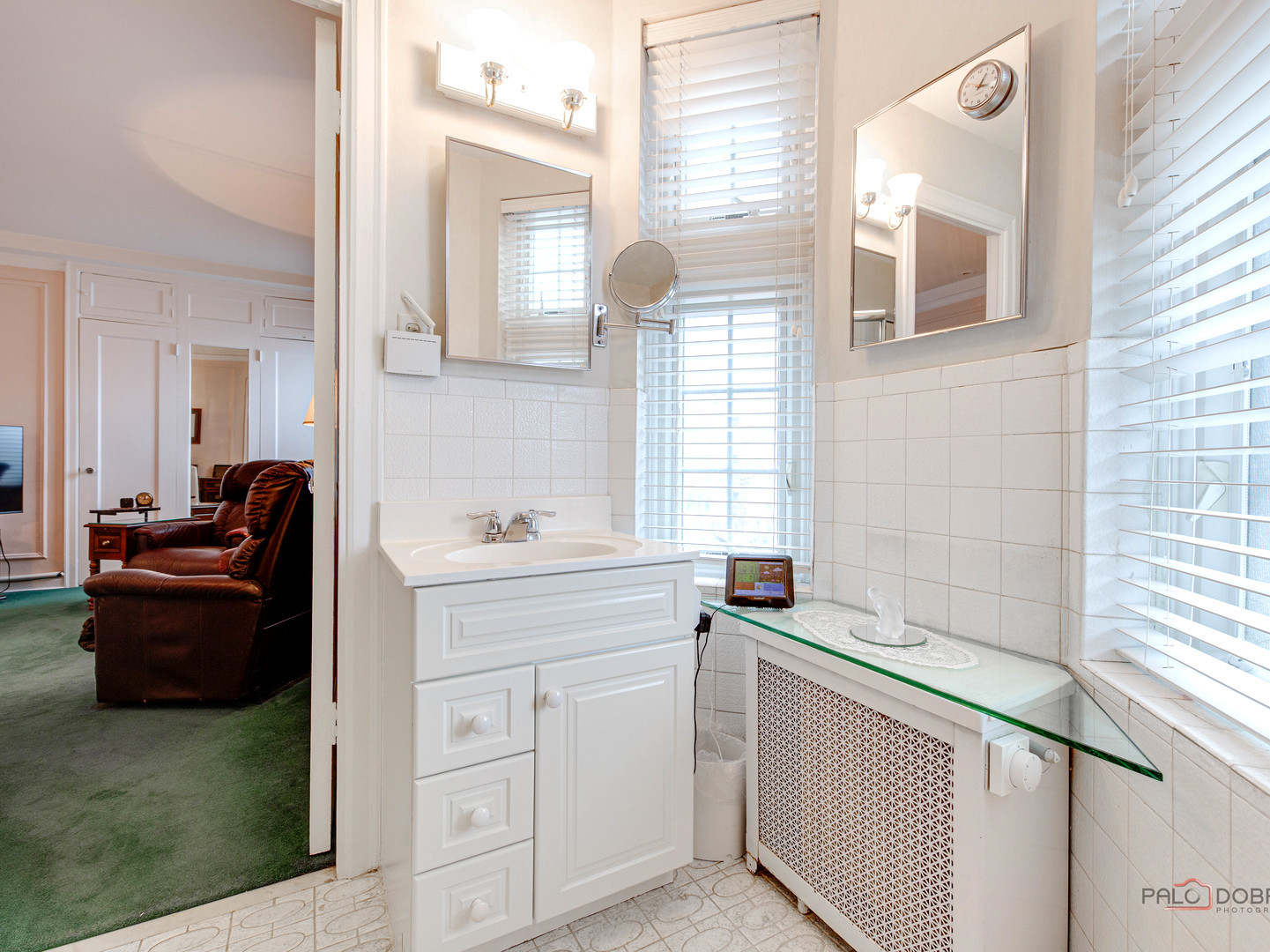 6342 North Sheridan Road, Unit 2B Chicago, IL 60660 - Photo 10 of 18 a view of a bathroom with a sink a window and a mirror