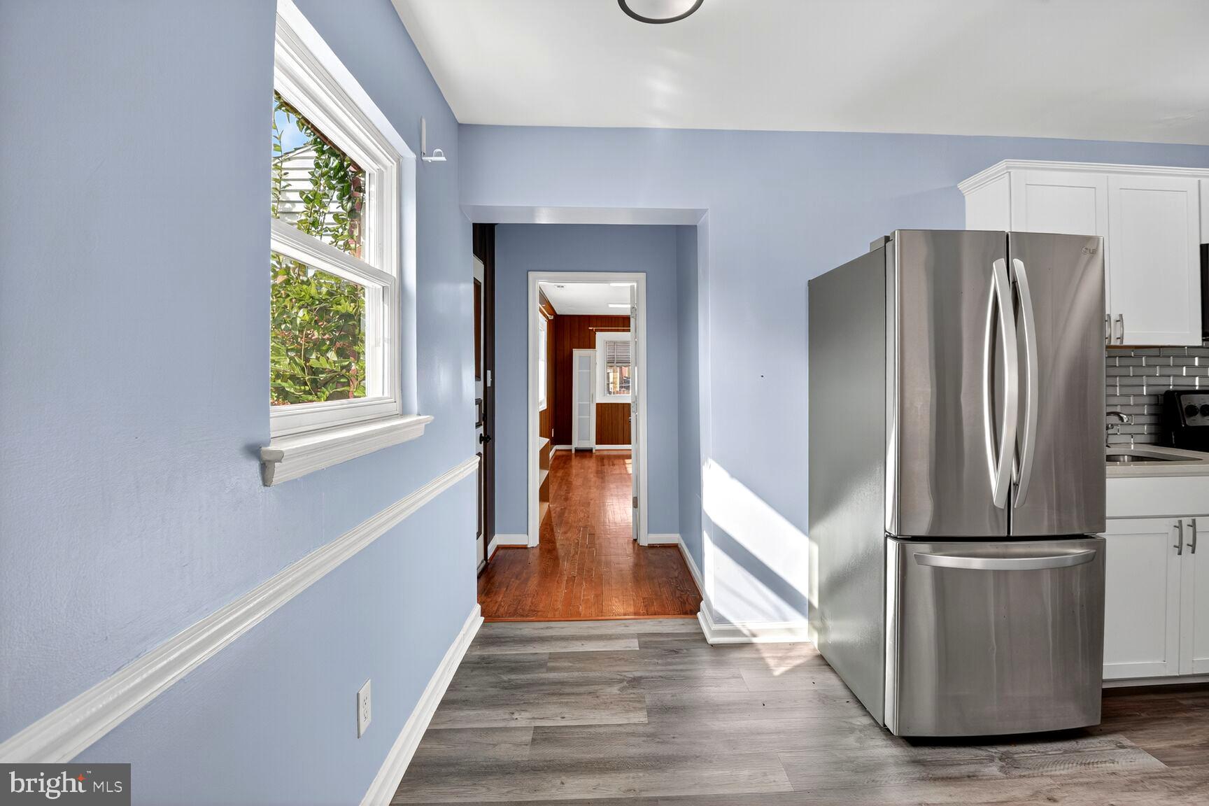 8204 17th Avenue Hyattsville, MD 20783 - Photo 11 of 36 a view of hallway with wooden floor and stairs
