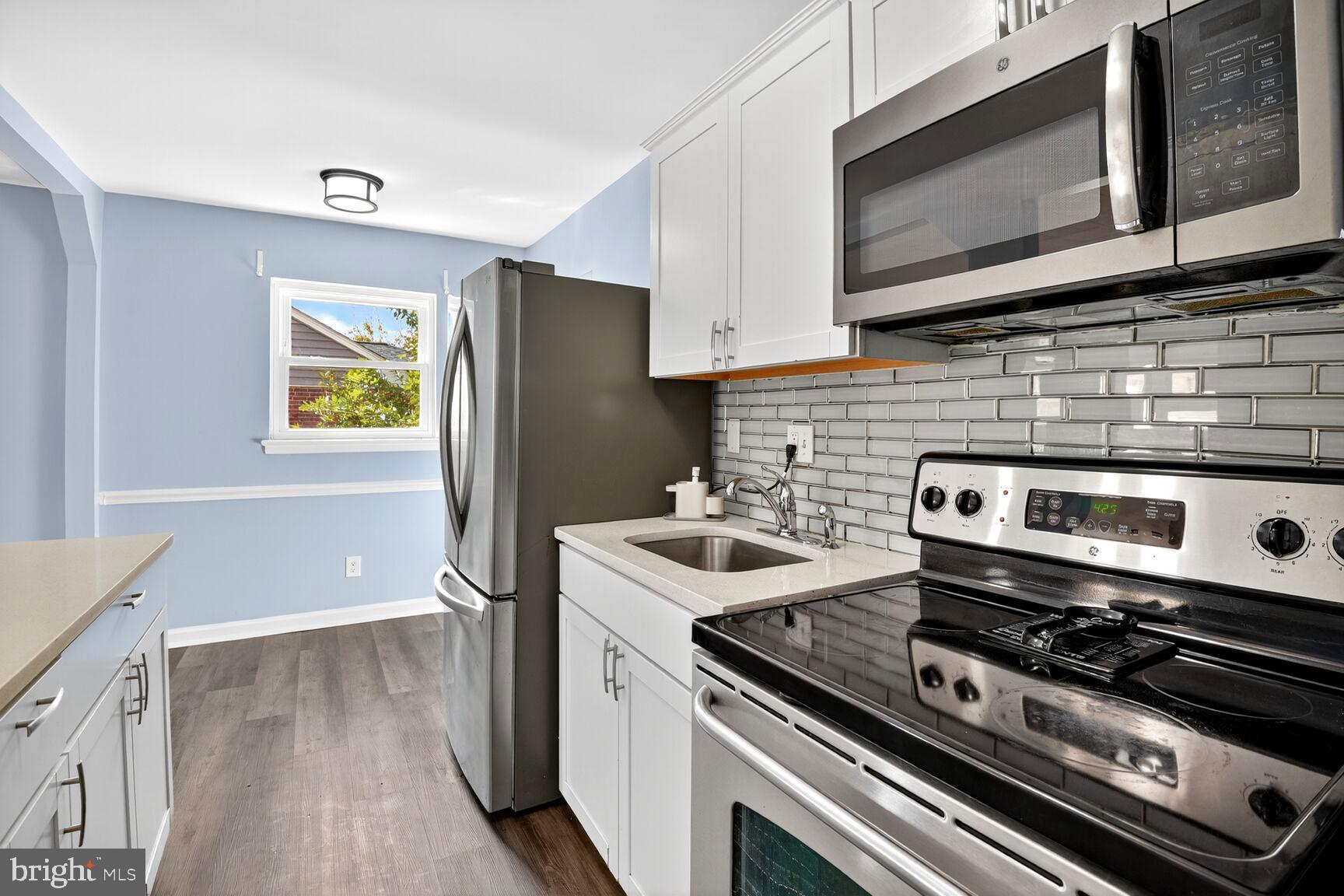 8204 17th Avenue Hyattsville, MD 20783 - Photo 13 of 36 a kitchen with a stove and a microwave
