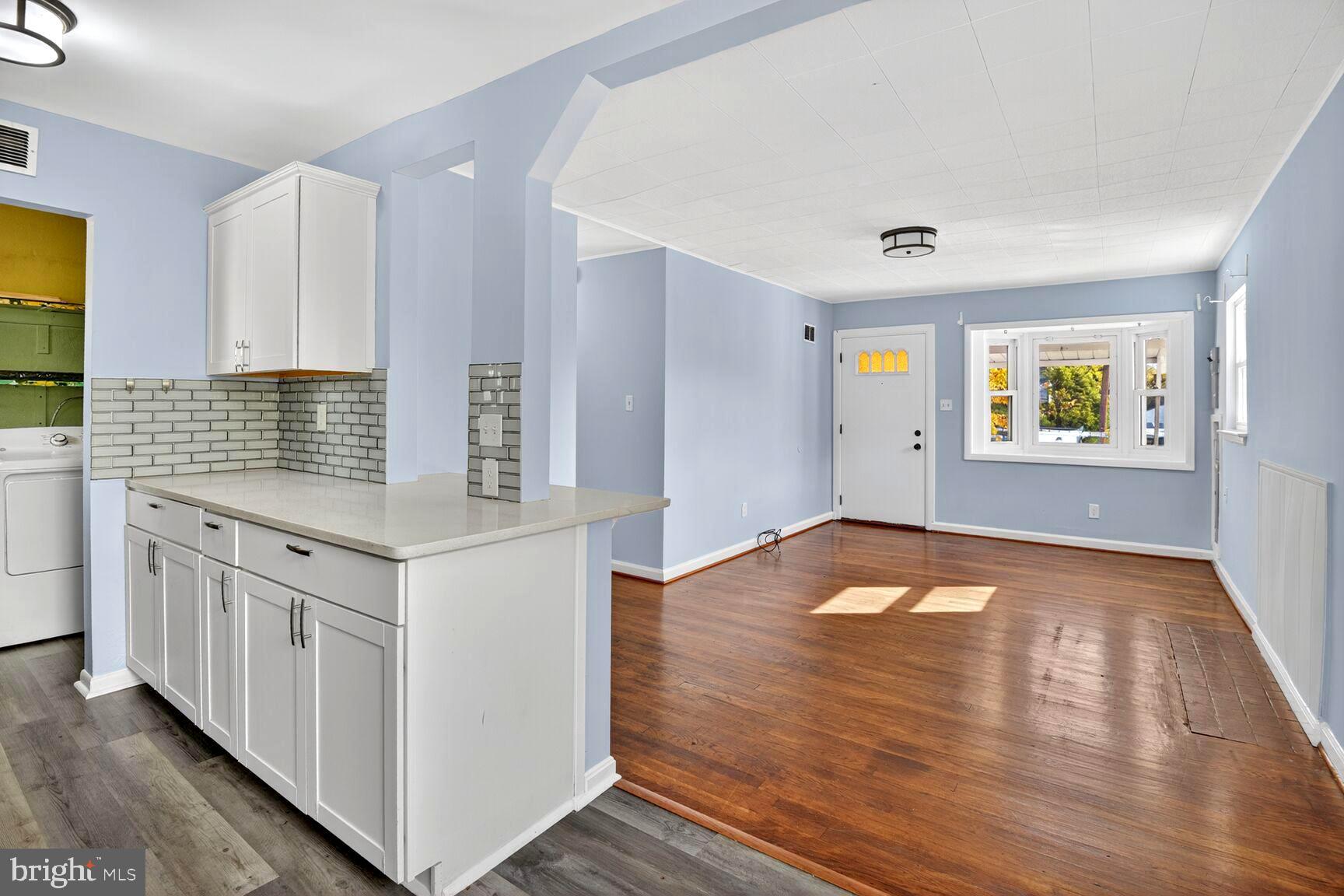 8204 17th Avenue Hyattsville, MD 20783 - Photo 14 of 36 a view of empty room with wooden floor and window
