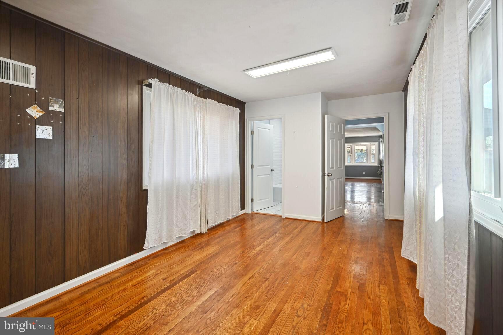 8204 17th Avenue Hyattsville, MD 20783 - Photo 18 of 36 a view of empty room with wooden floor