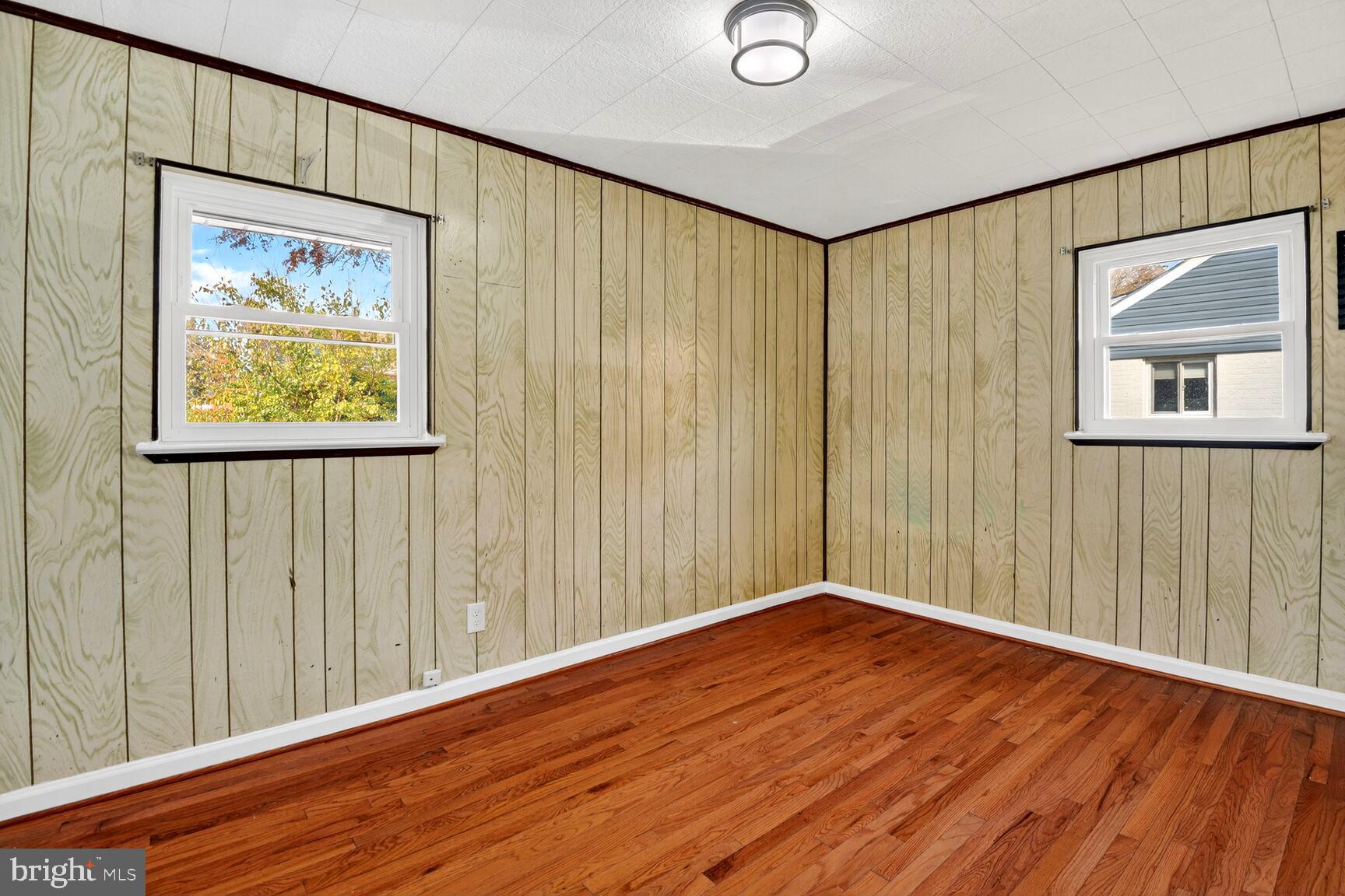8204 17th Avenue Hyattsville, MD 20783 - Photo 24 of 36 a view of an empty room with wooden floor and a window