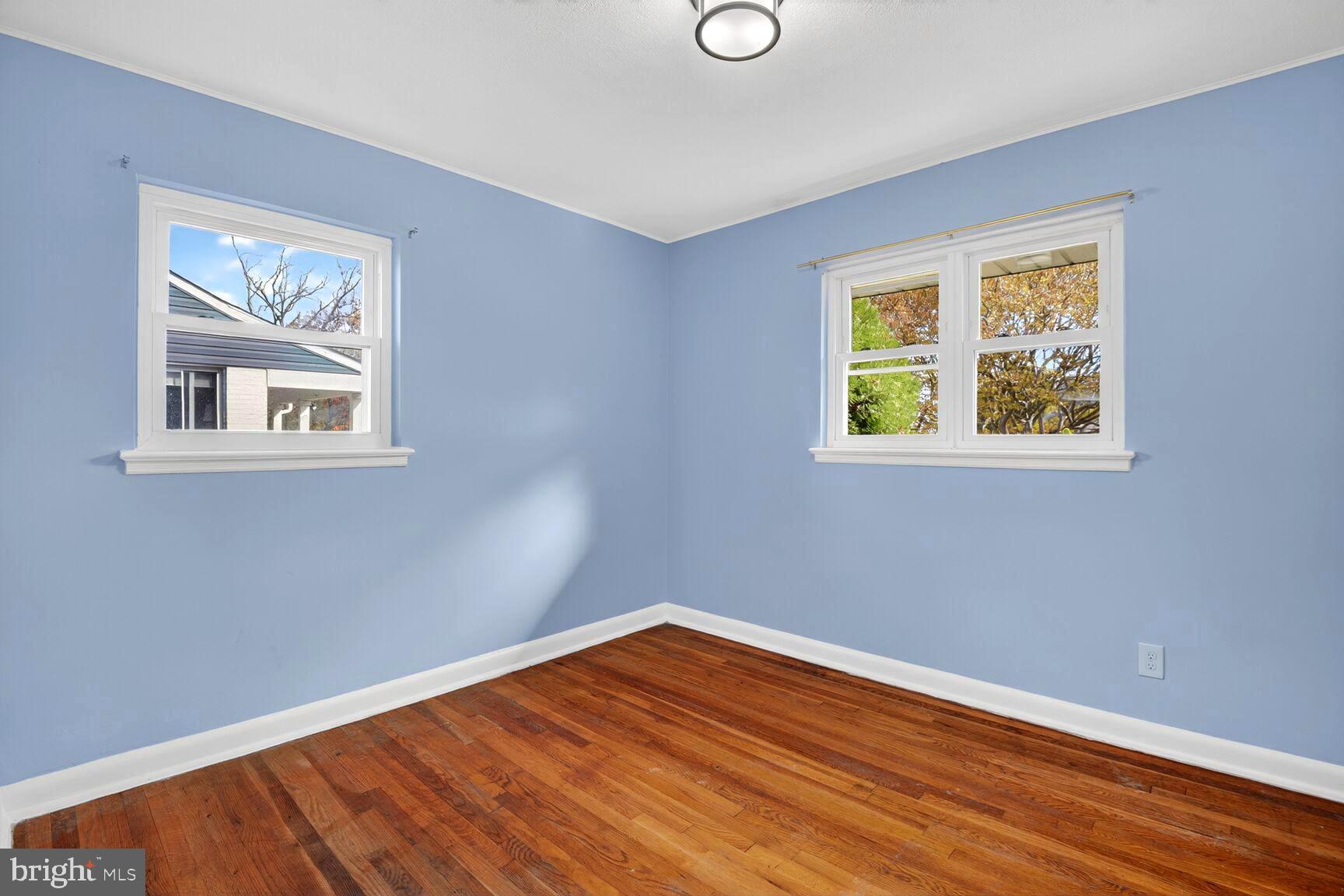 8204 17th Avenue Hyattsville, MD 20783 - Photo 26 of 36 a view of an empty room with wooden floor and a window