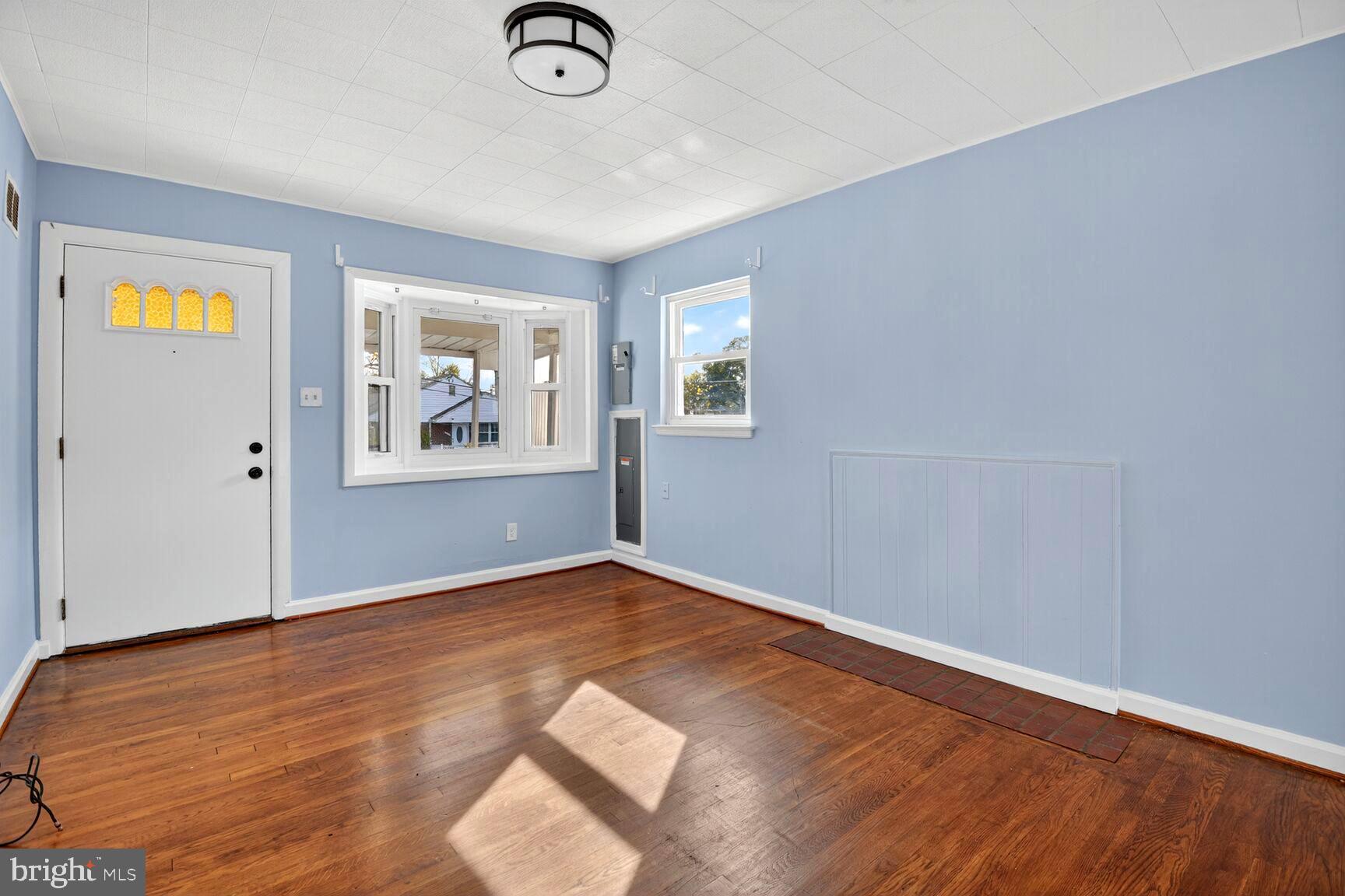 8204 17th Avenue Hyattsville, MD 20783 - Photo 6 of 36 an empty room with window and wooden floor
